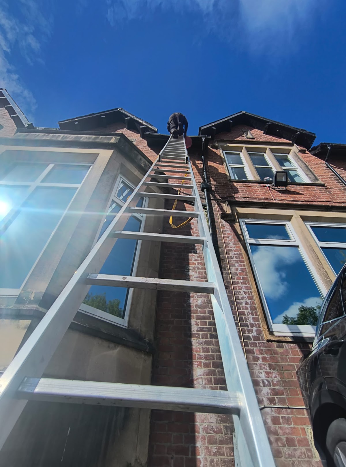 F P Turner working on the guttering of a Victorian house in Preston