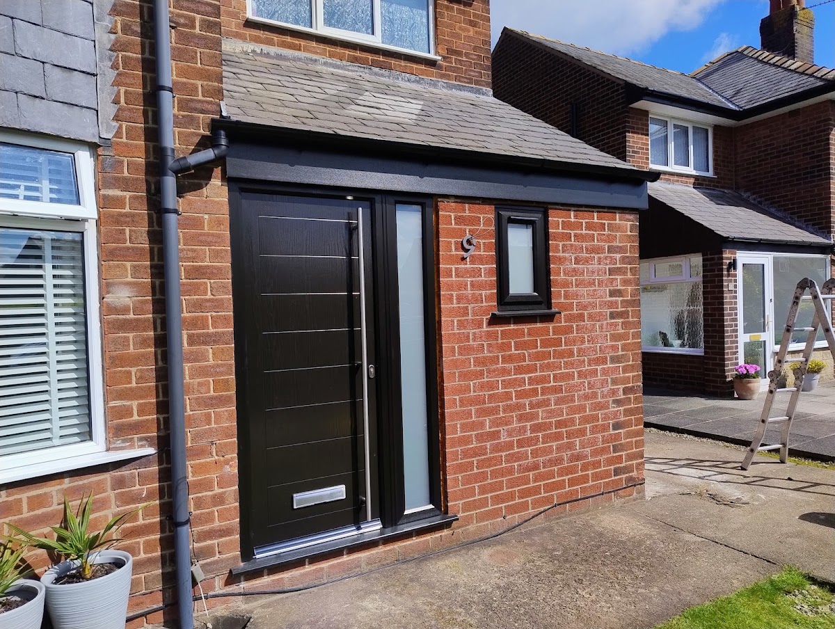 New fascia, soffit and downpipe above a black composite front door