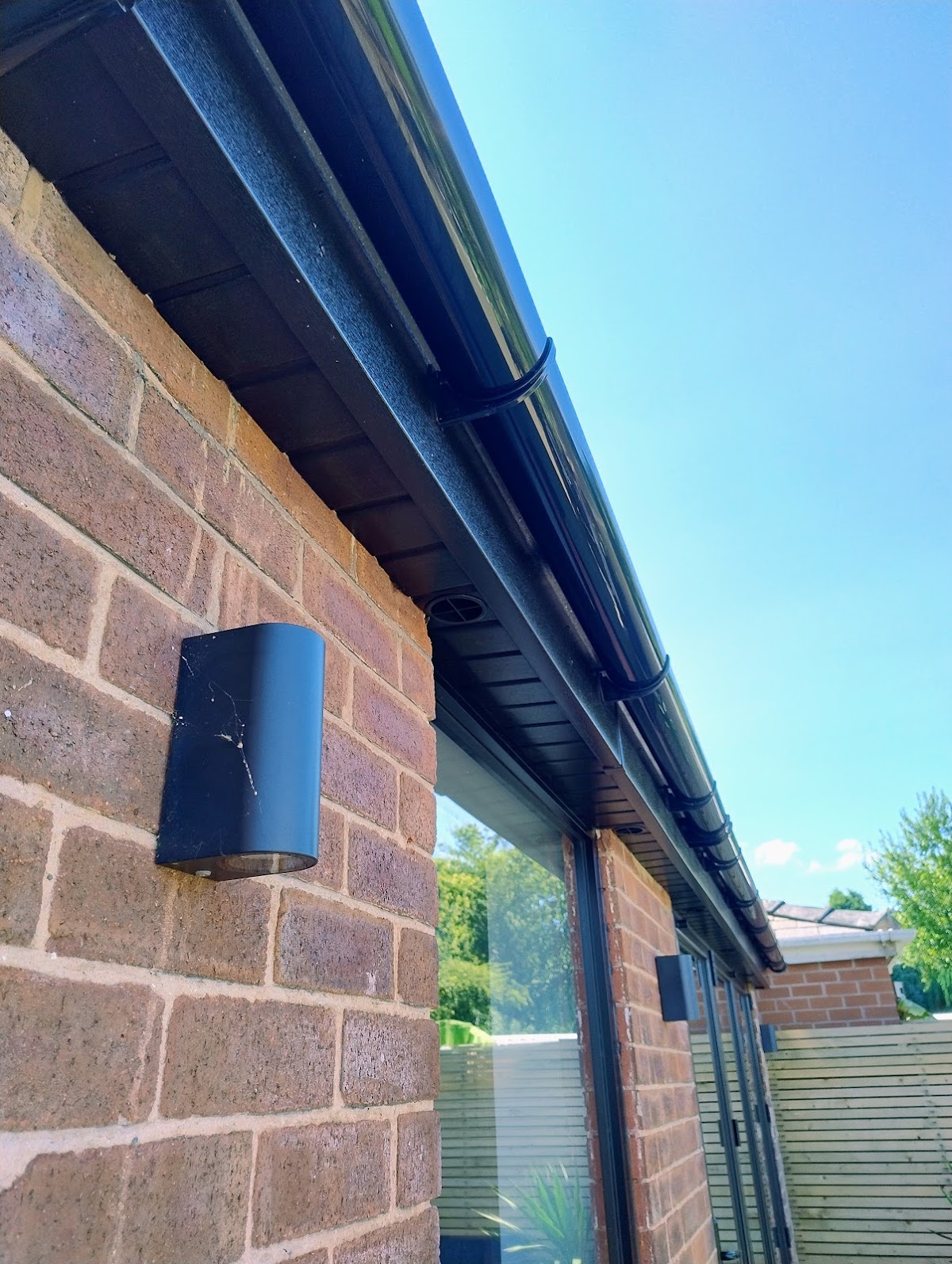 New black fascia, soffit and guttering along the eaves